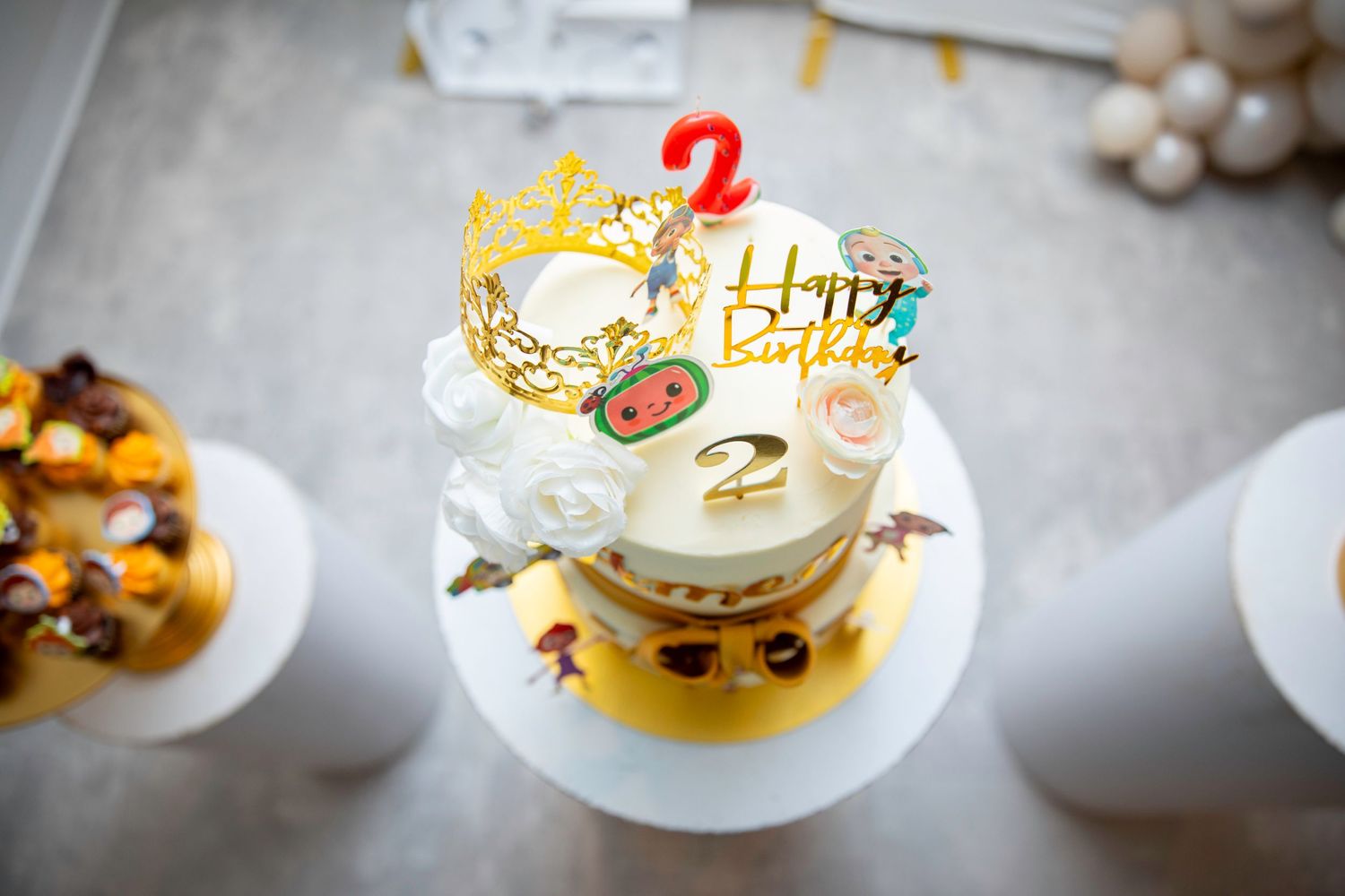 A festive birthday cake with decorative toppers and question mark candle.