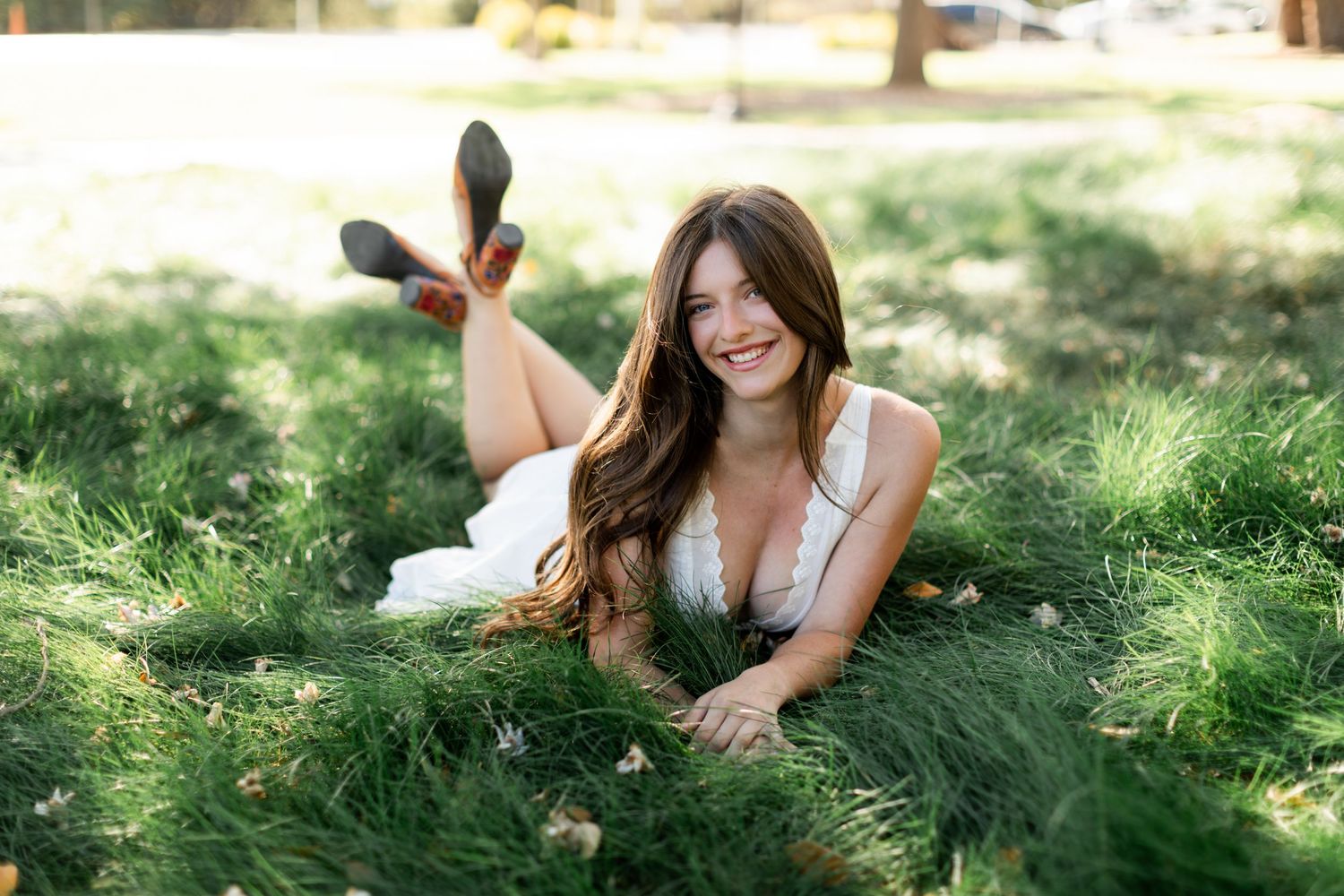 Backlit portrait of a woman smiling in natural sunlight outdoors.