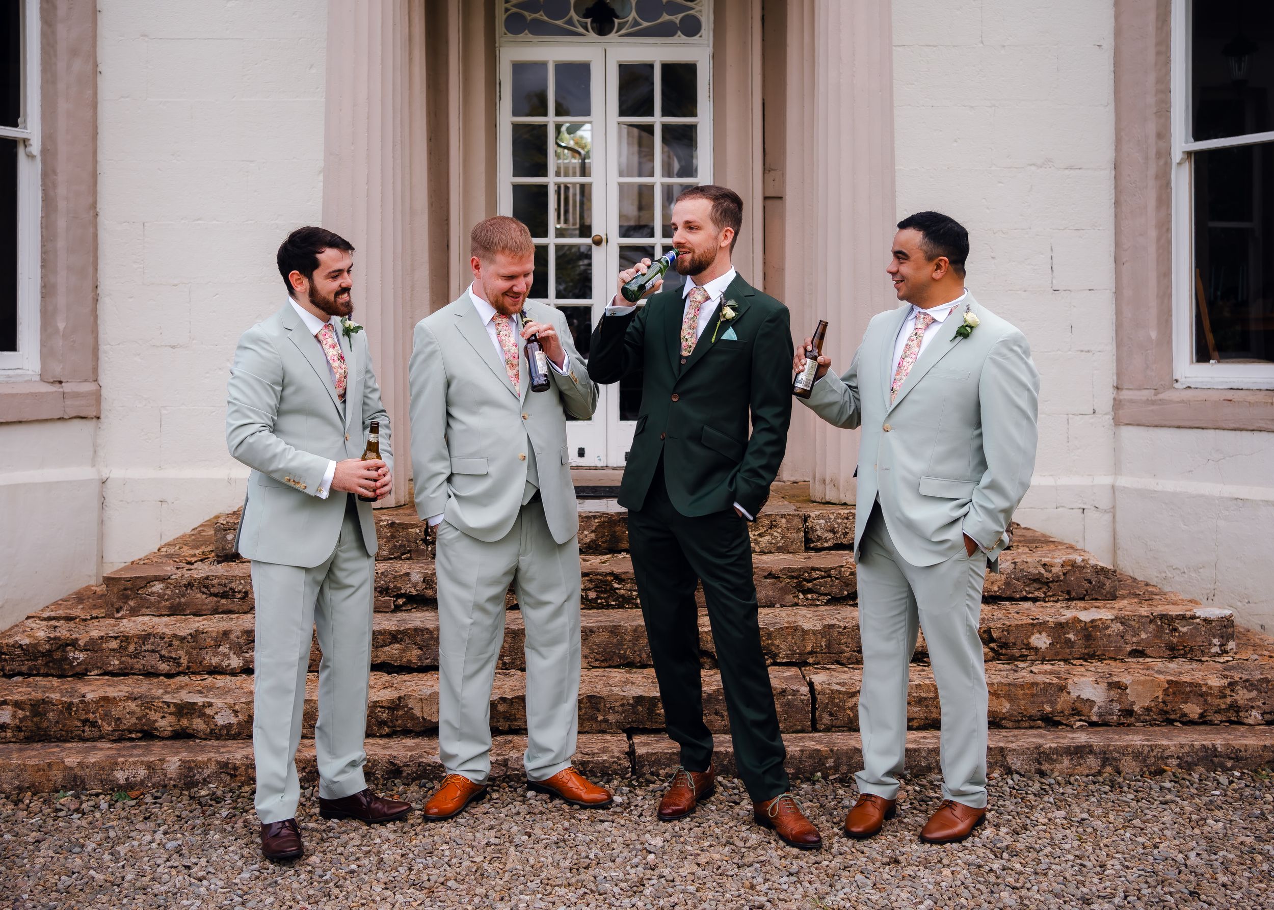non-traditional wedding photographer in the Lake District - groom having a drink with wedding party