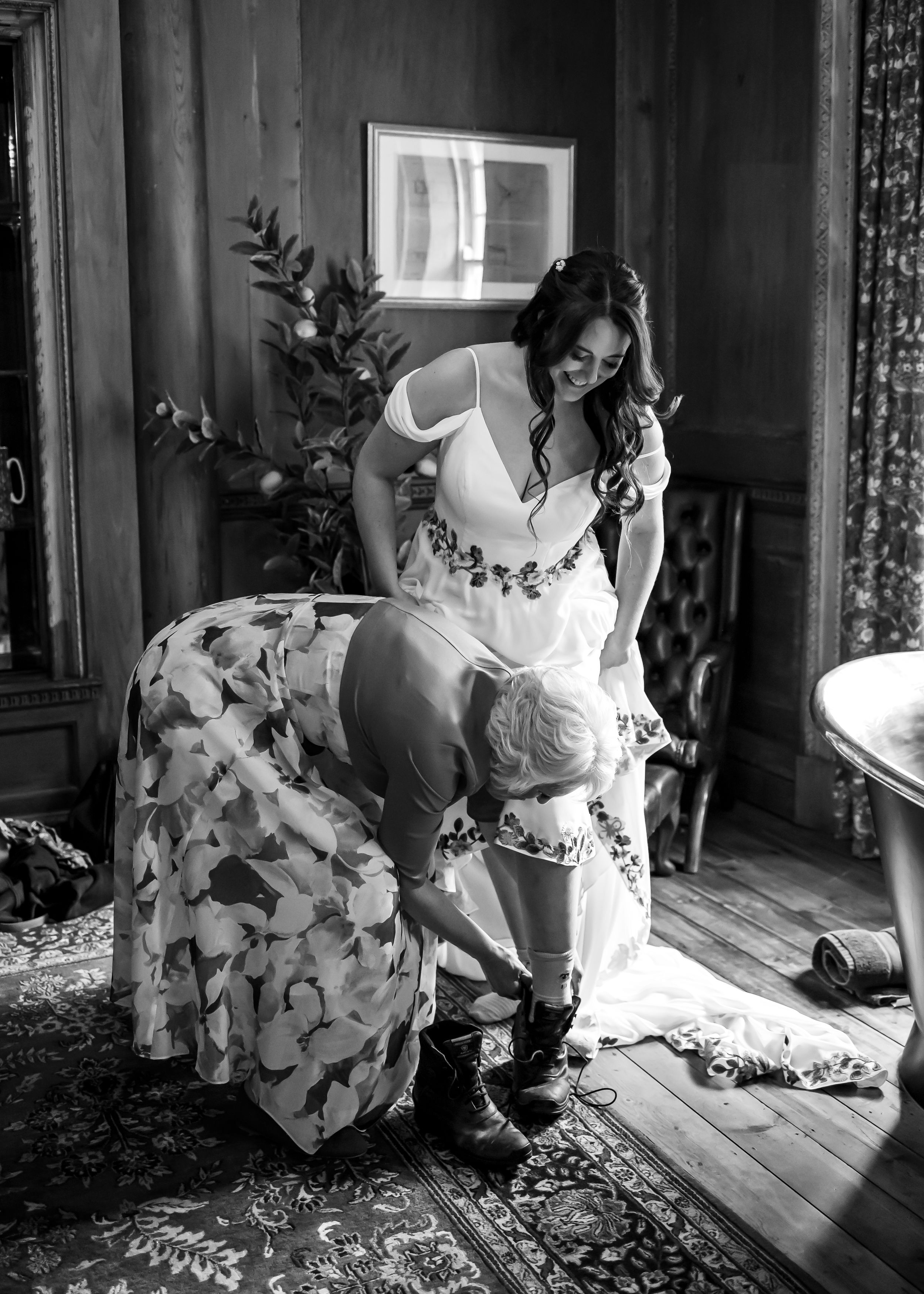 non-traditional wedding photographer in the Lake District - bride putting on her riding boots