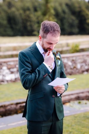 non-traditional wedding photographer in the Lake District - groom reading vows
