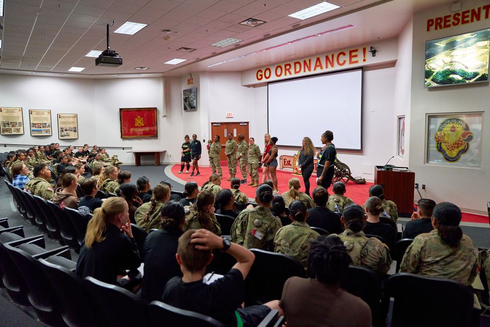 Military audience gathered in an auditorium for a presentation under Go Ordnance banner.