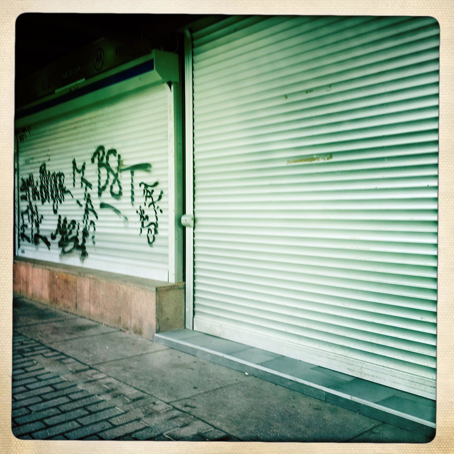 Graffiti on some closed store front.