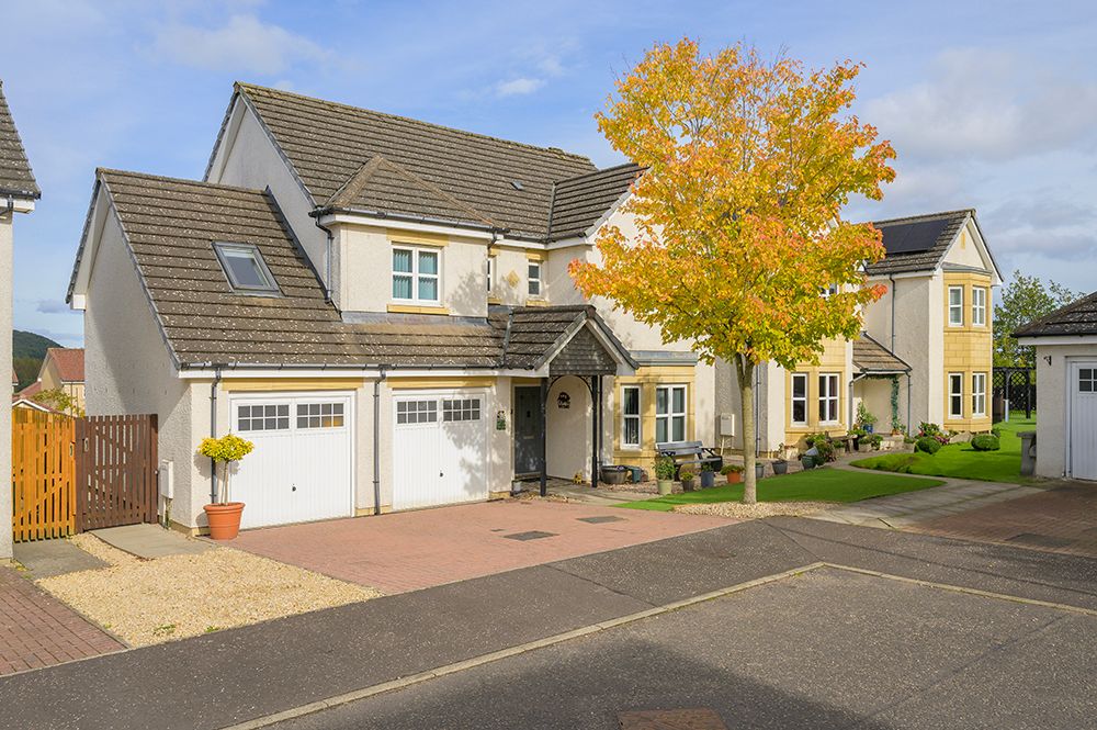 Exterior of large detached property on a sunny day in autumn scotland