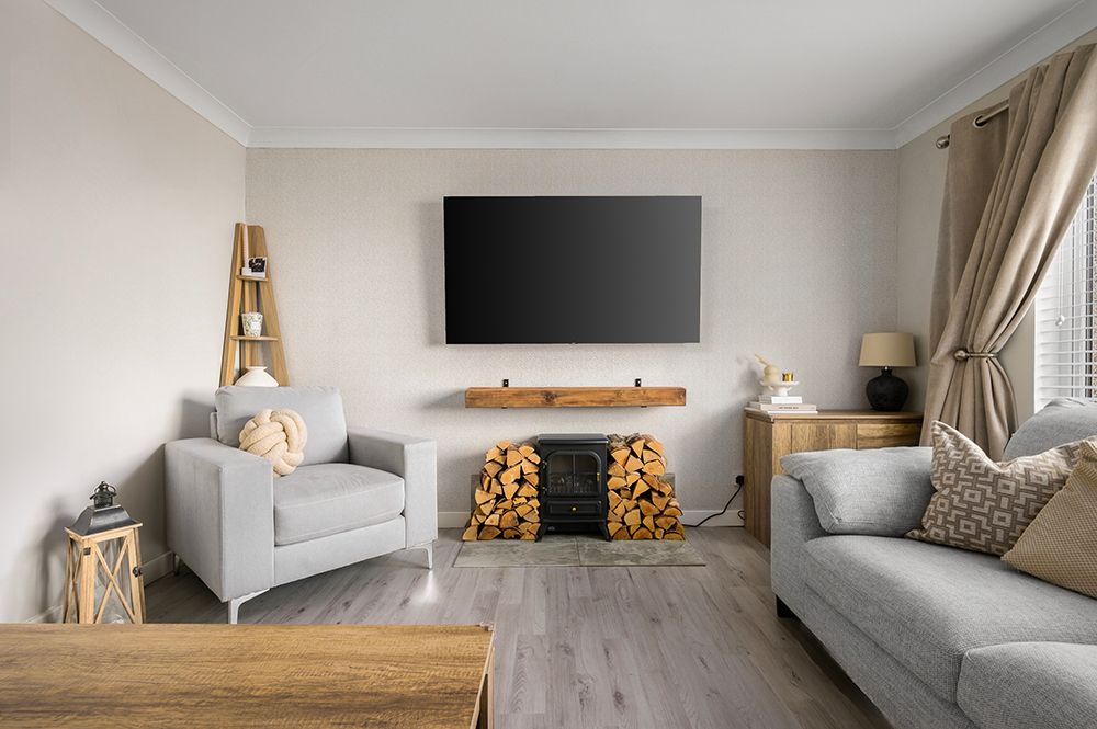 stylish lounge with log burner and neutral furnishings, photographed for air bnb host.