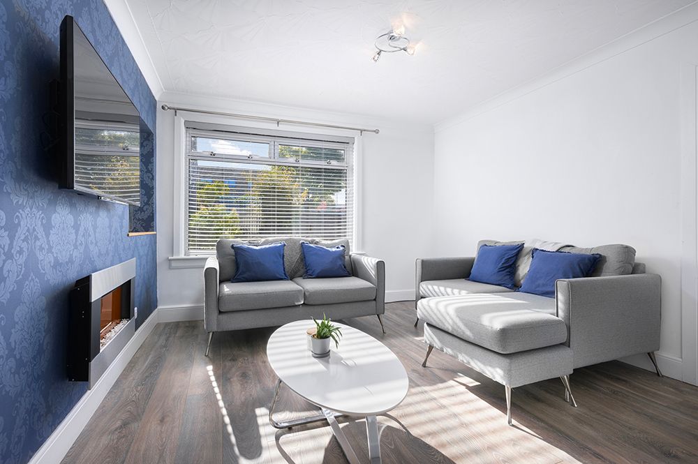 stylish blue and grey living area in semi detached house in west lothian.