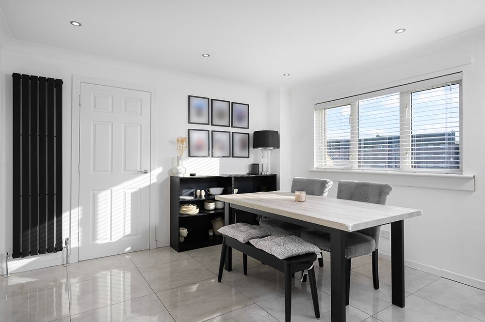 Luxury photography listing of spacious dining area with family dining table. Grey and black furnishings