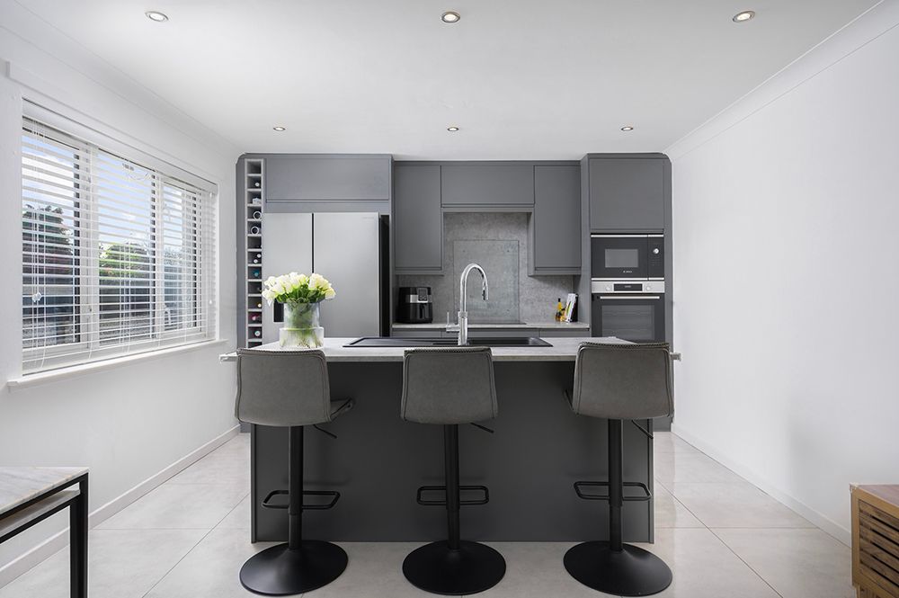 Stylish modern kitchen with center island. Fininshed in black and white slate. Interior designer kitchen.