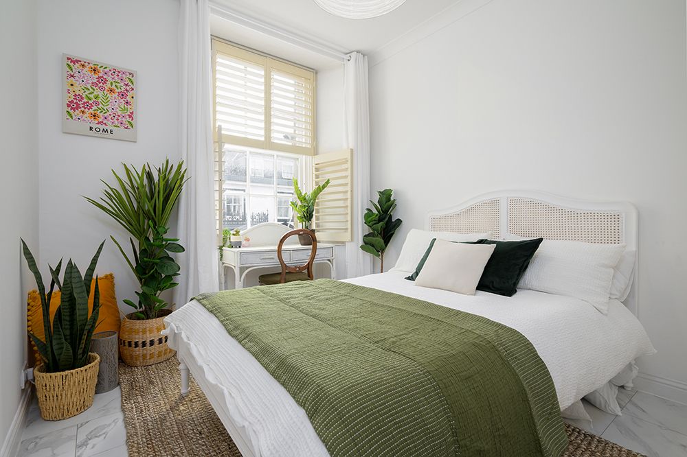 upper level bedroom styled with earthy tones. Airbnb listing photography.
