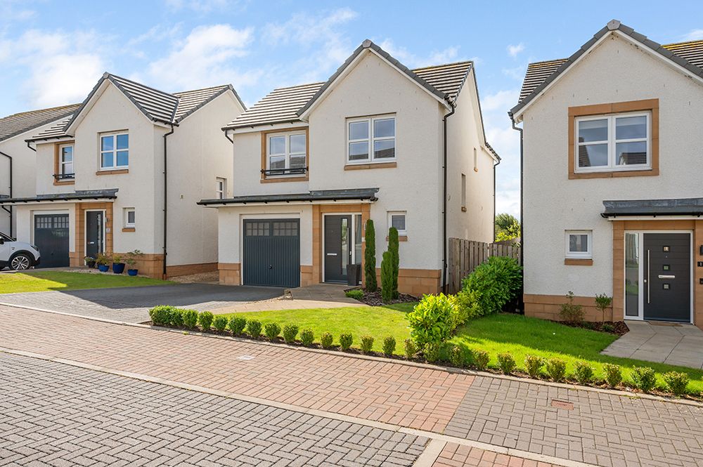 housing estate external photograph of property listing. Landscaped front garden and single driveway.