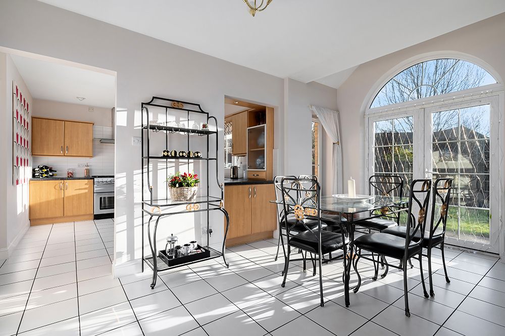 large dining area looking onto kitchen area and garden through french doors on a sunny day. property listing for west lothian estate agent.