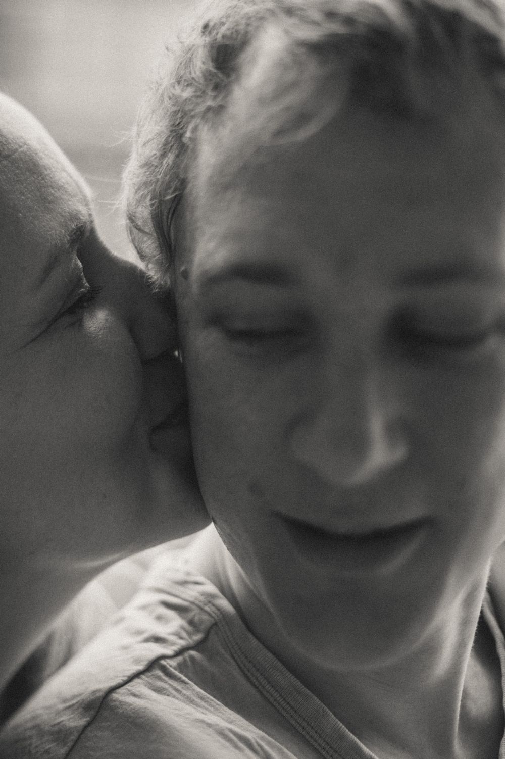 Close-up black and white portrait showing genuine emotion.