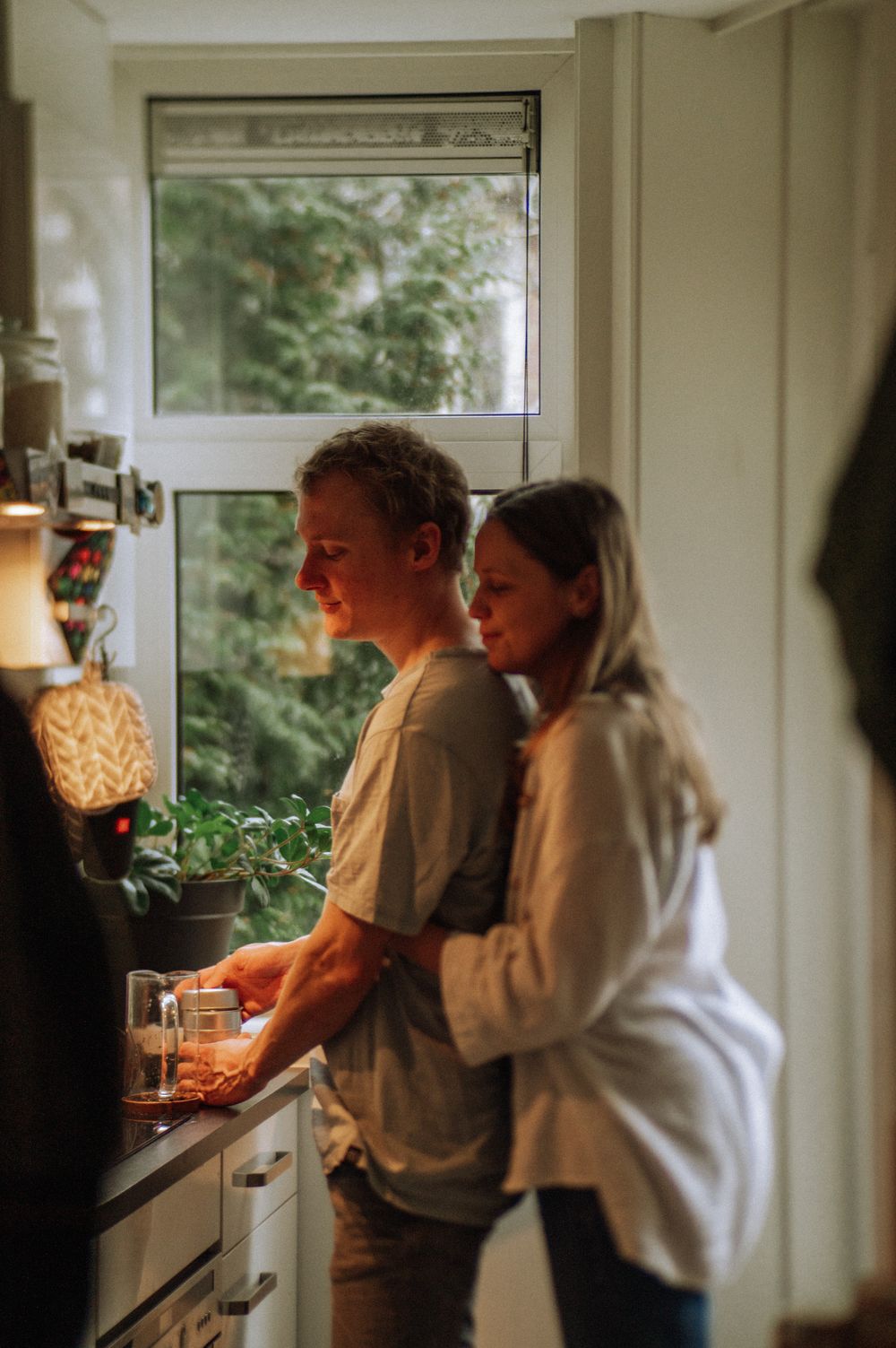 Couple spending time together in a bright, modern kitchen.