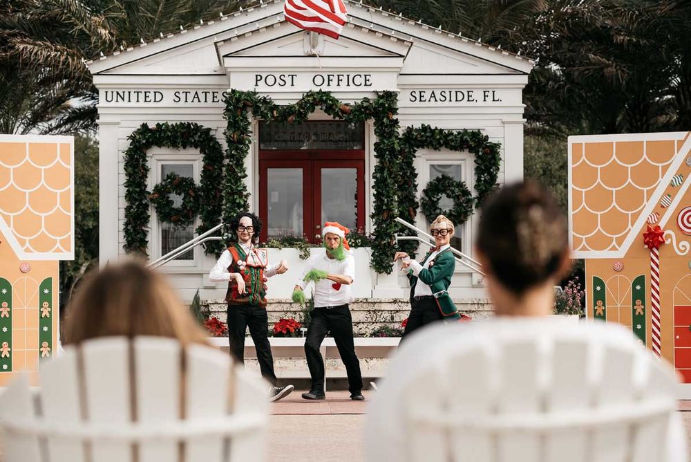 Post office building decorated for holidays with American flag and festive decor.