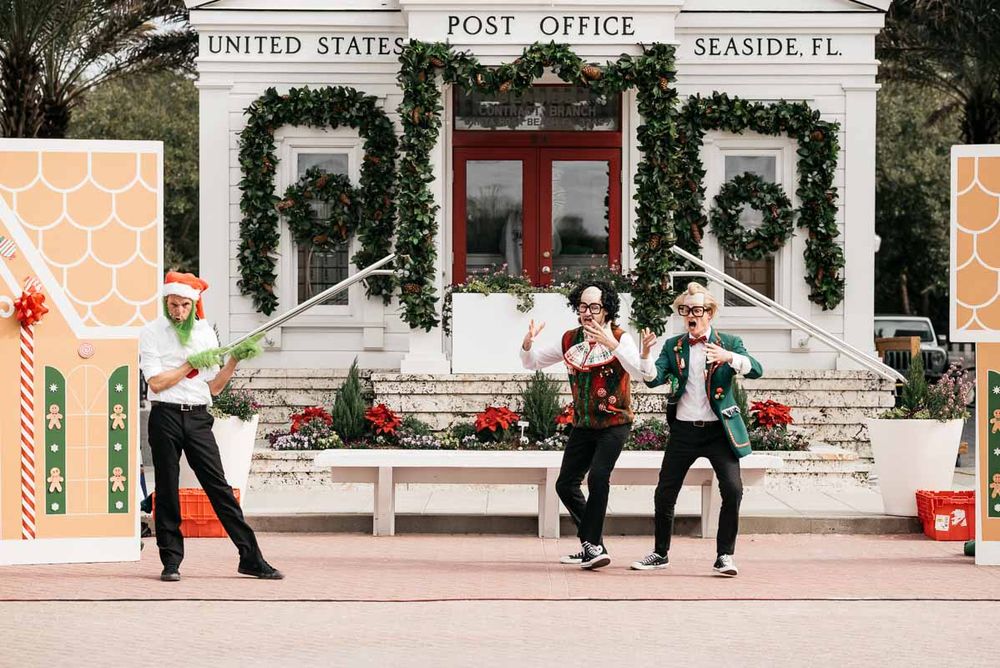 Seaside Post Office facade with Christmas decorations and pedestrians walking past.