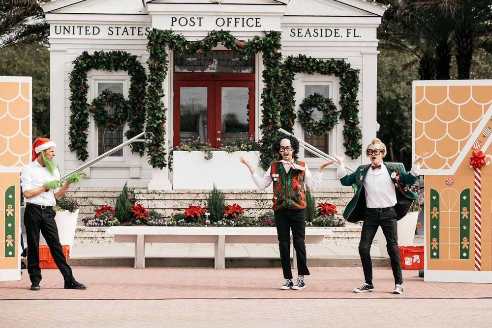 Post office exterior with holiday decorations and people walking on the sidewalk.