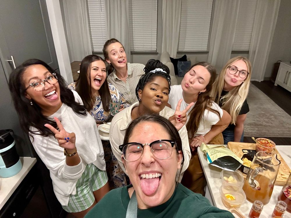 A group enjoying a lively dinner party gathering with food and drinks.
