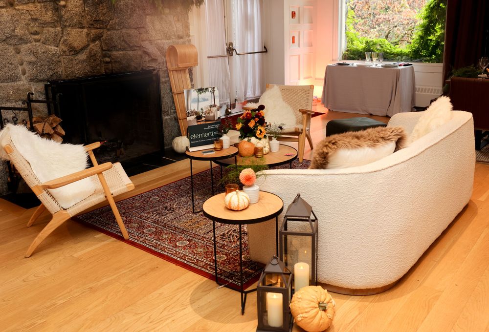 Cozy lounge area with modern furniture, lanterns and stone fireplace.