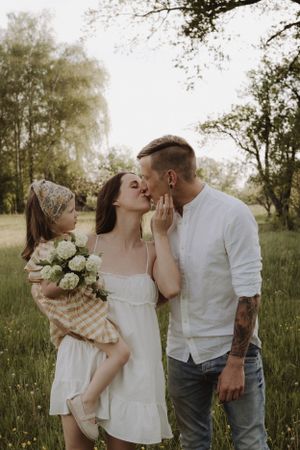 A romantic spring photoshoot featuring white roses and intimate moments in a meadow.
