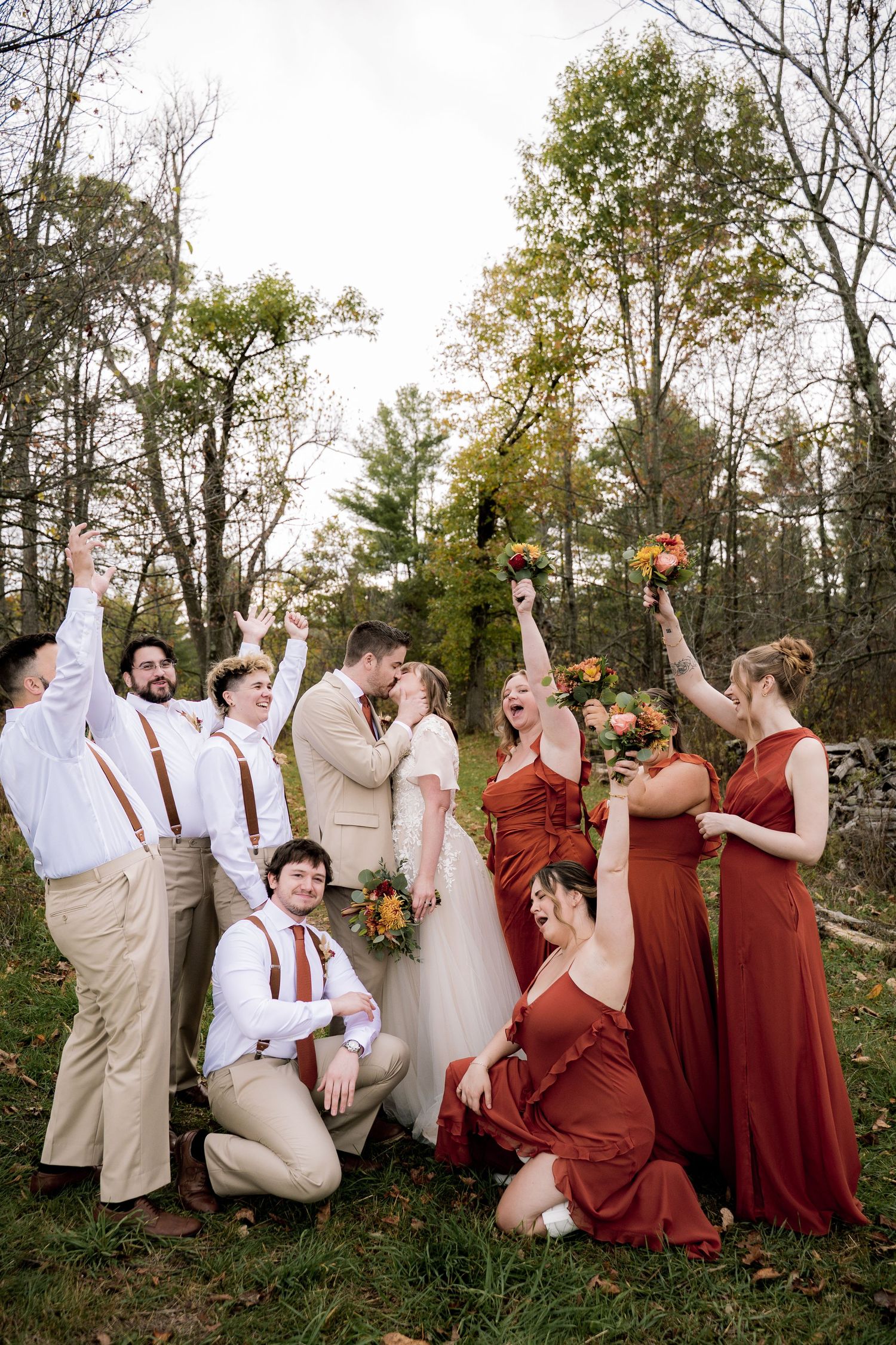 Wedding party celebrates with confetti and joy in black and white outdoor ceremony.