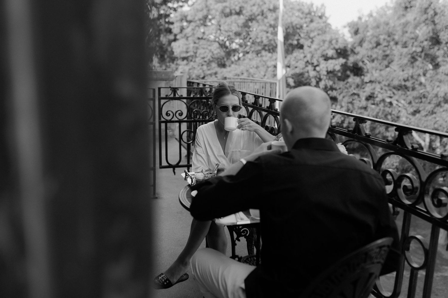 Bride and groom sharing an intimate breakfast on a sunlit balcony at Maryhill Estate, Sweden – a quiet moment before their wedding day.