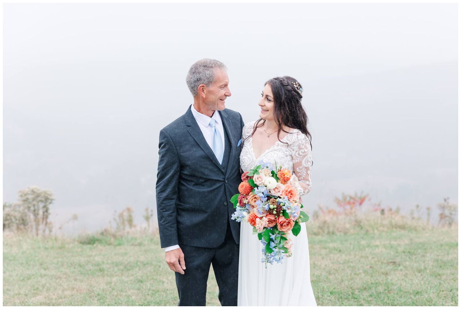 Elegant outdoor wedding ceremony portraits captured against a misty natural landscape.