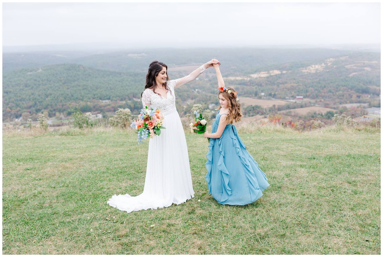 Scenic outdoor wedding photos on a hilltop with white and blue dresses against a natural landscape backdrop.