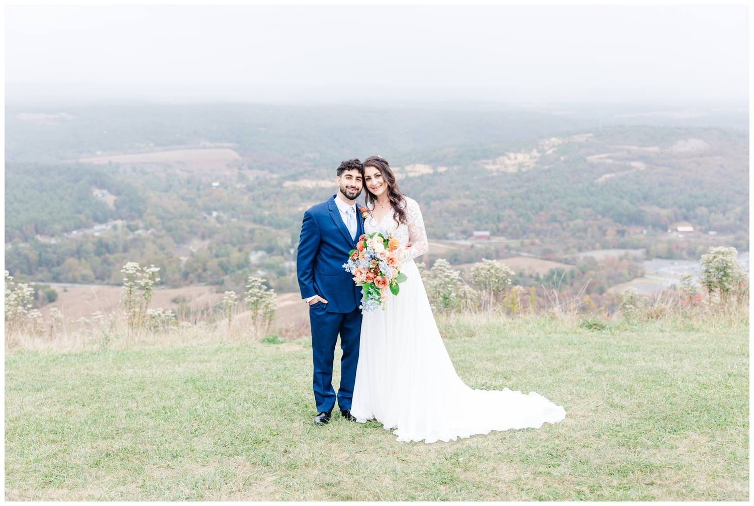 Rolling hills and autumn landscape create a scenic backdrop for an outdoor celebration.