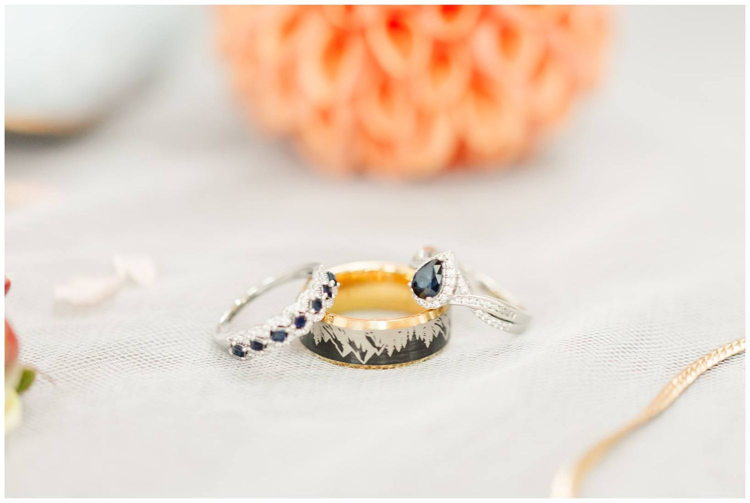 Wedding rings and jewelry details with coral colored flowers and delicate accessories.