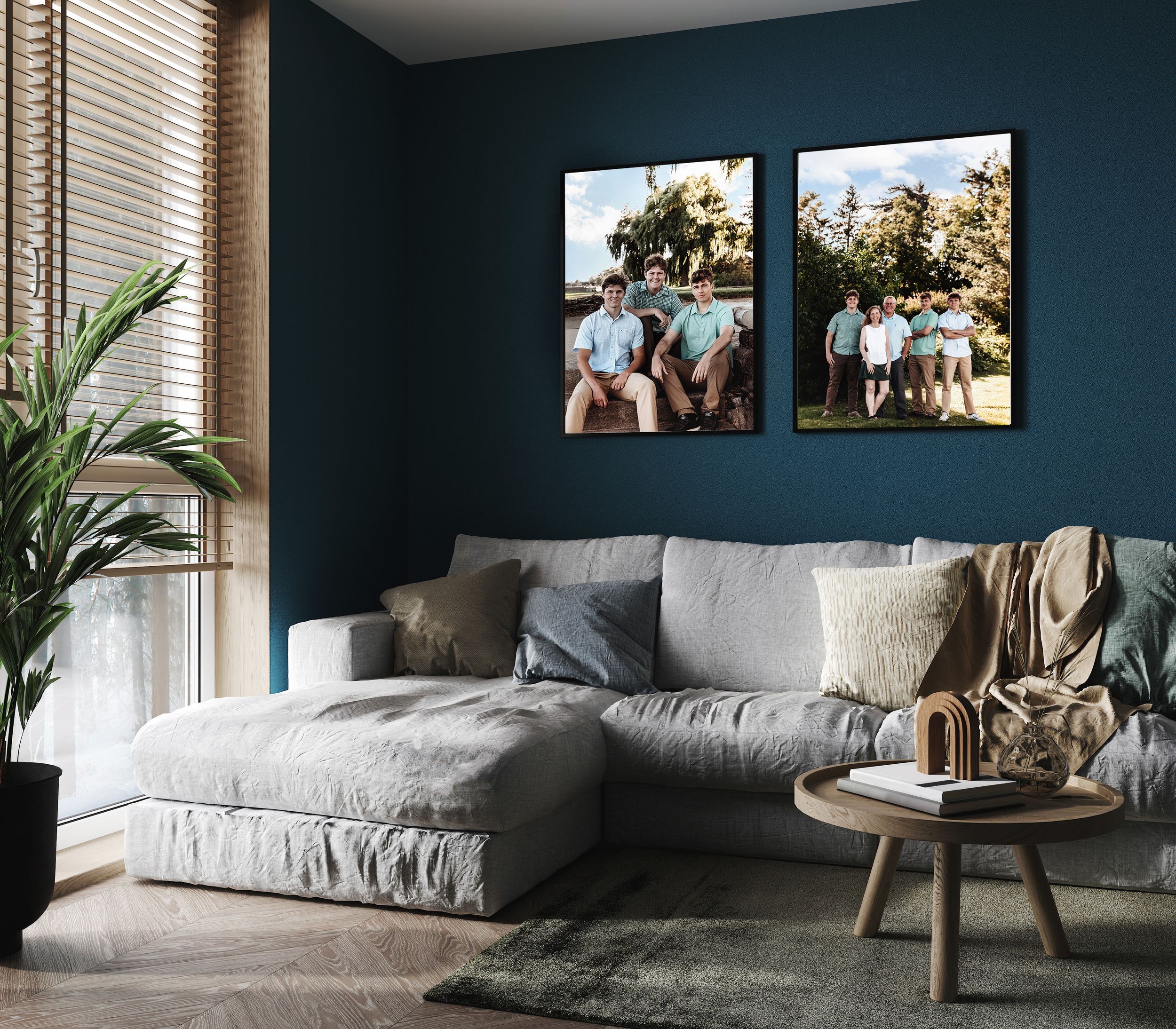 Modern living room with dark teal walls features a plush gray sectional sofa and framed artwork.