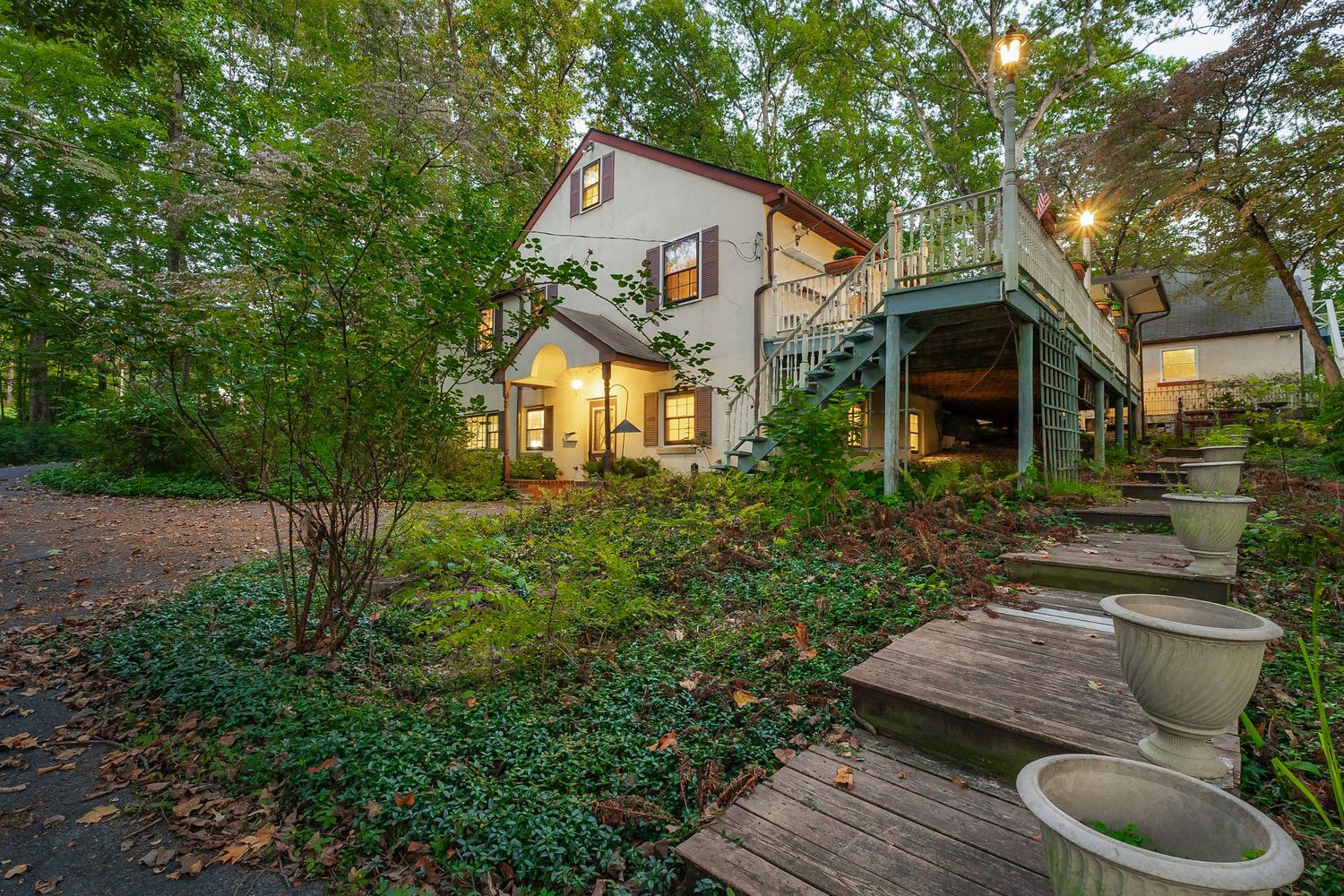 Landscaped walkway with stone steps and garden features leading to a residential entrance.