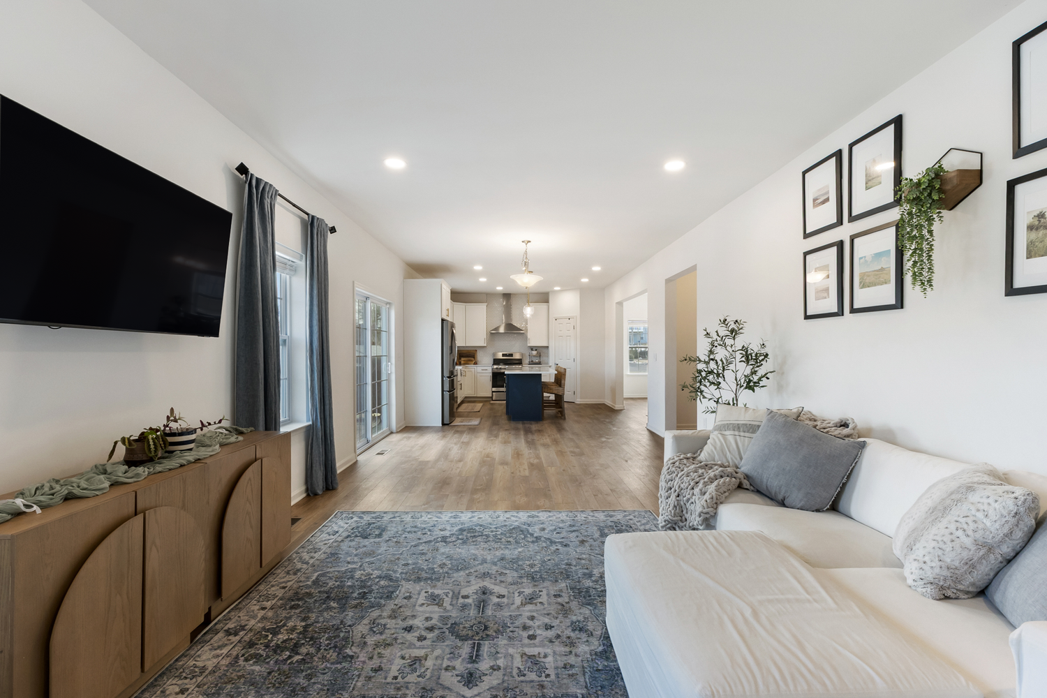 Modern interior hallway with white walls, hardwood floors, and recessed lighting showcases minimalist design elements.