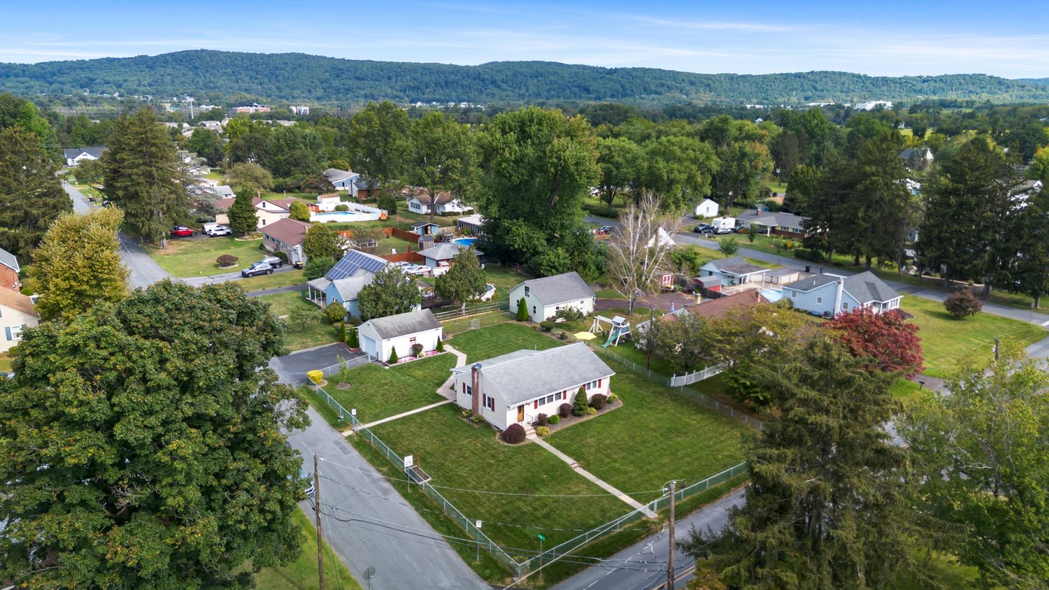 Aerial view of suburban neighborhood with mountain ranges in the background.