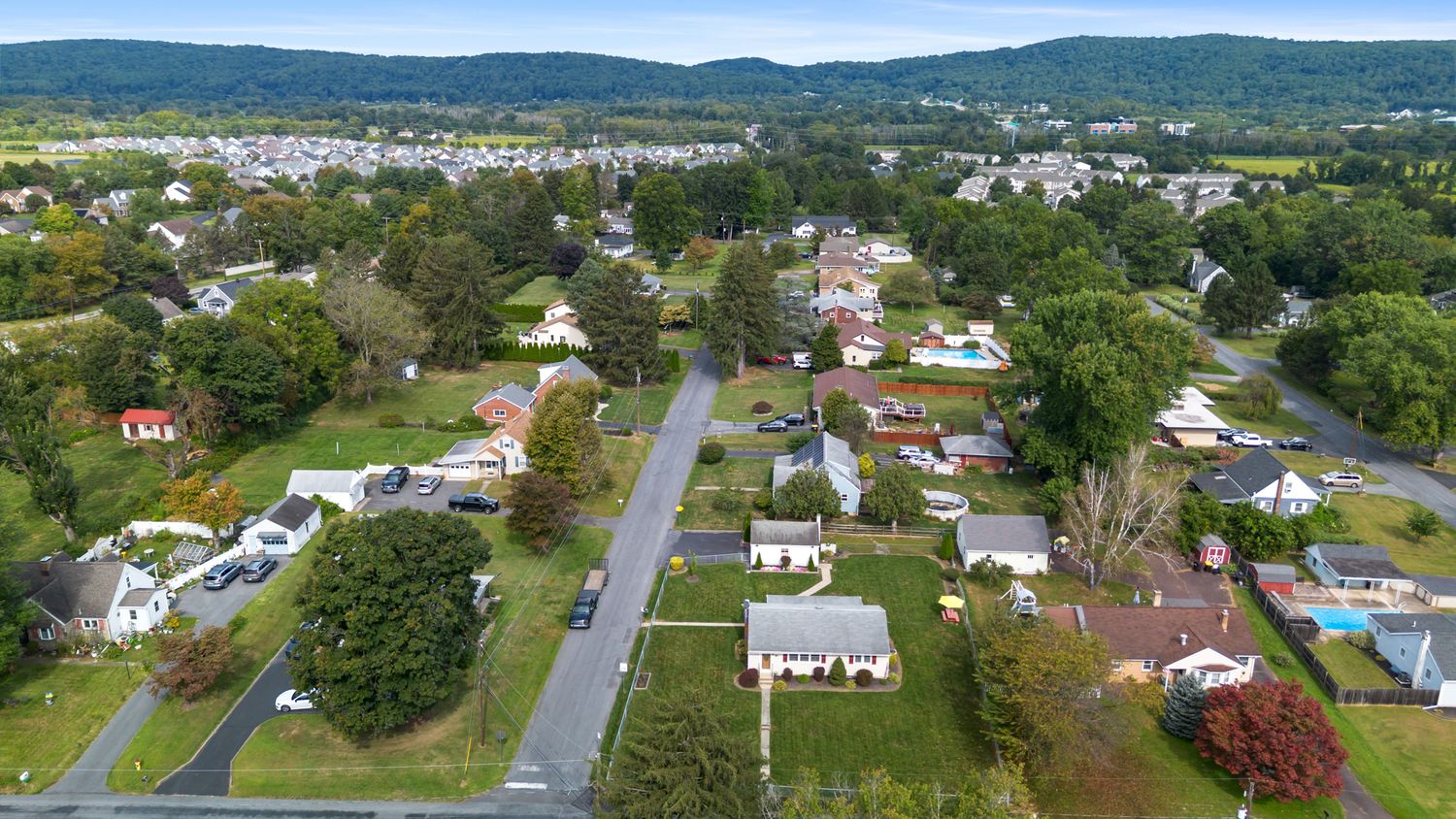 Drone perspective of residential streets and houses in a suburban community.