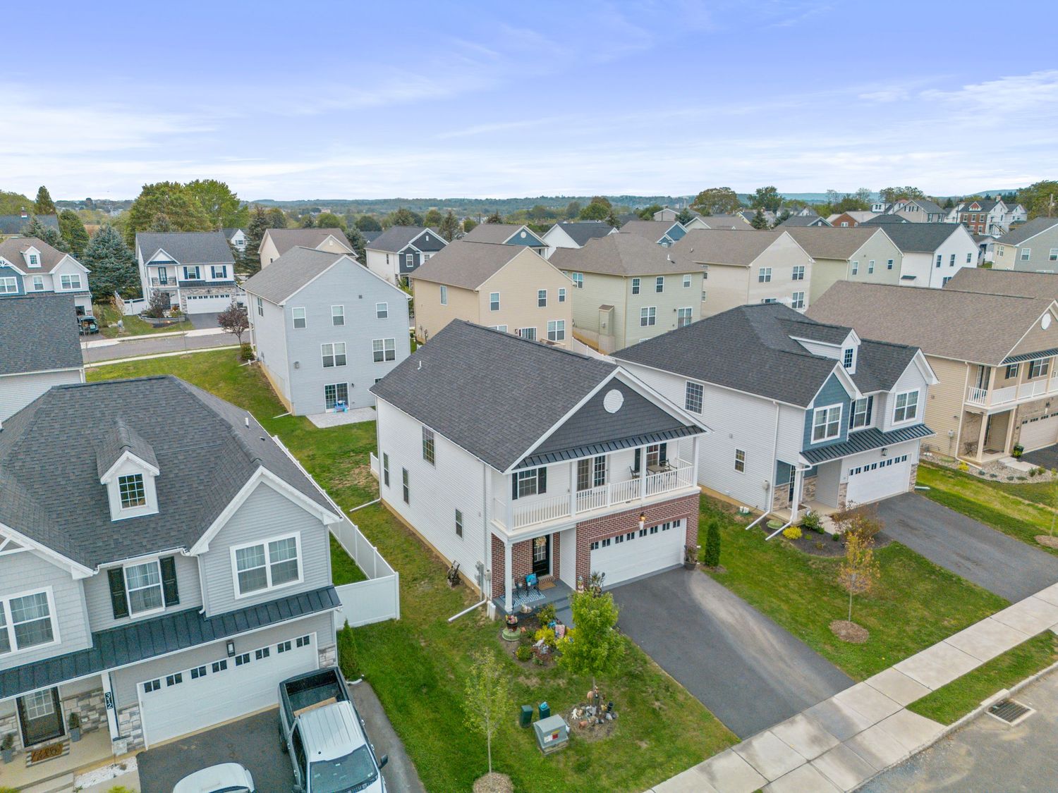 Aerial view of suburban neighborhood showing multiple residential homes and driveways.