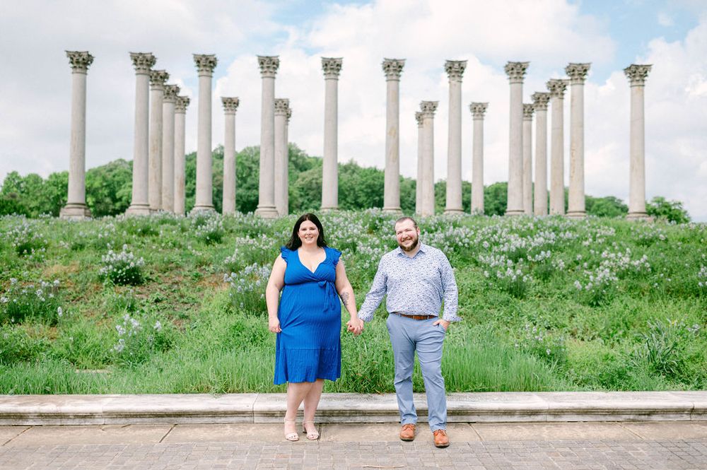 Two people stand in front of the historic National Capitol Columns at the National Arboretum in Washington DC.