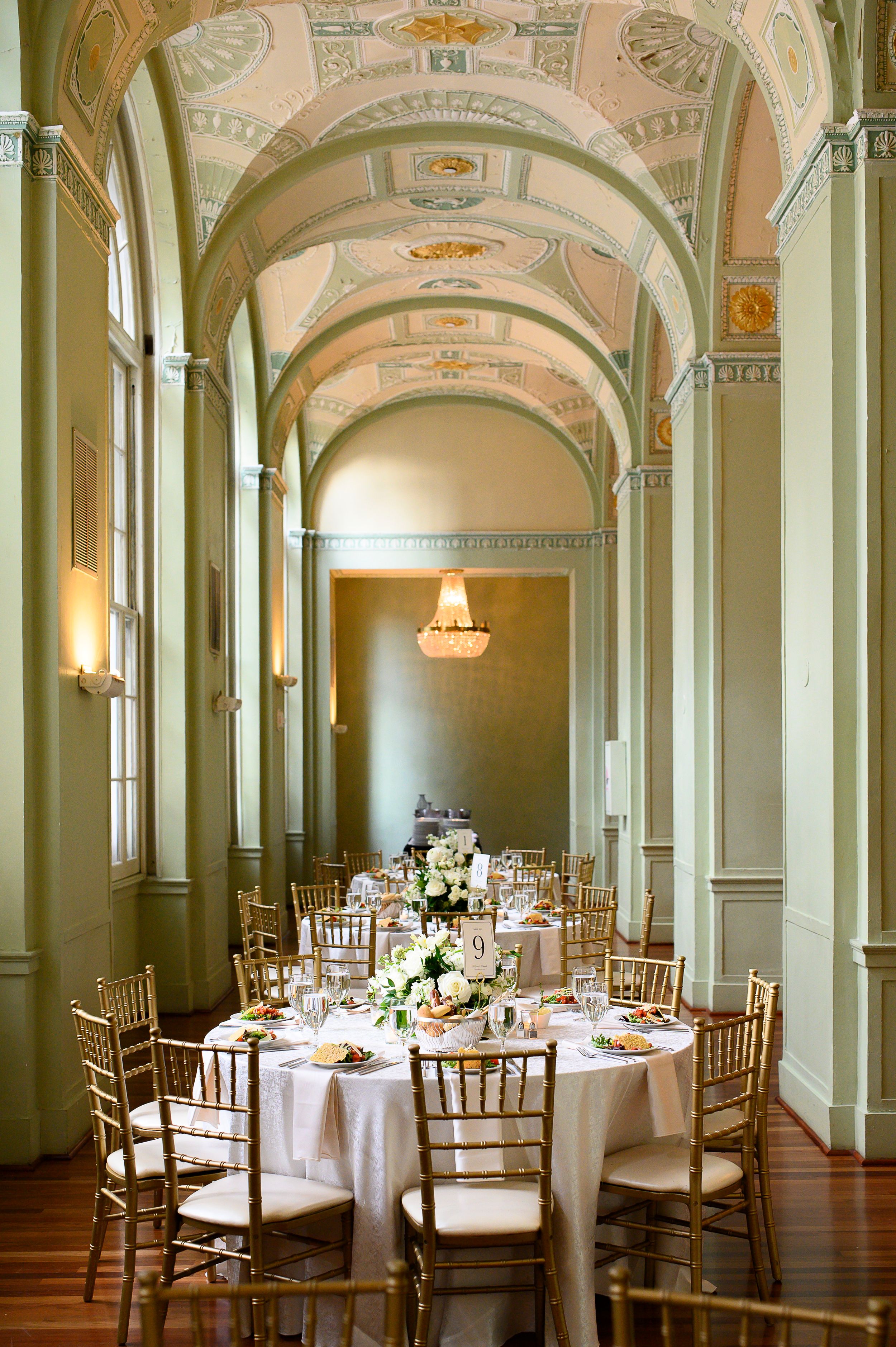 Elegant ballroom with arched ceilings and round dining tables set for a formal event at a historic venue. biltmore ballrooms wedding photos