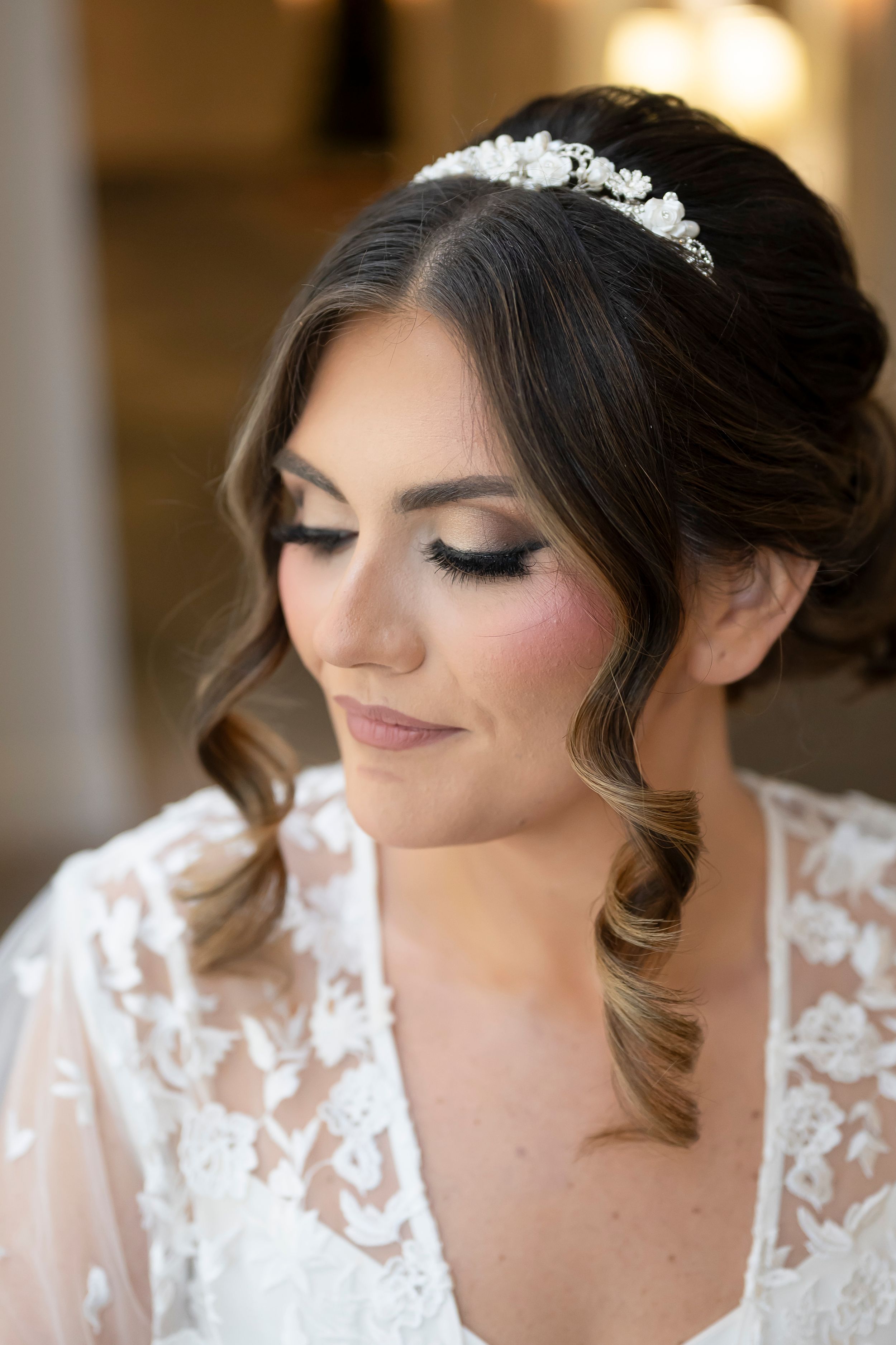 Bridal portrait showing elegant lace dress details and romantic makeup with eyes closed in soft lighting. Photos in Roswell, GA