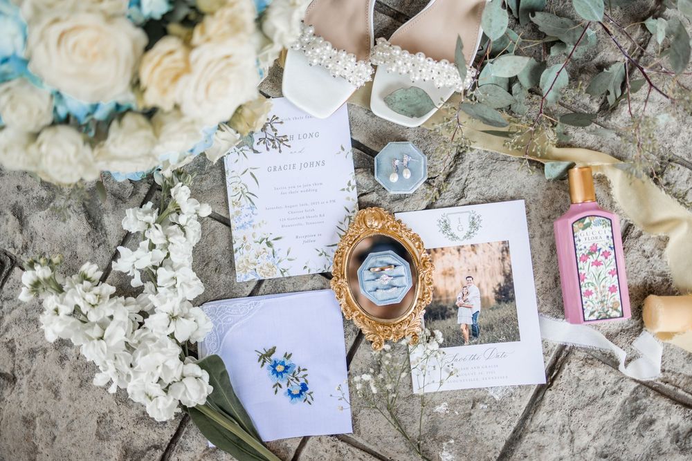 A collection of vintage-style paper crafts and ephemera arranged with dried flowers and decorative elements.