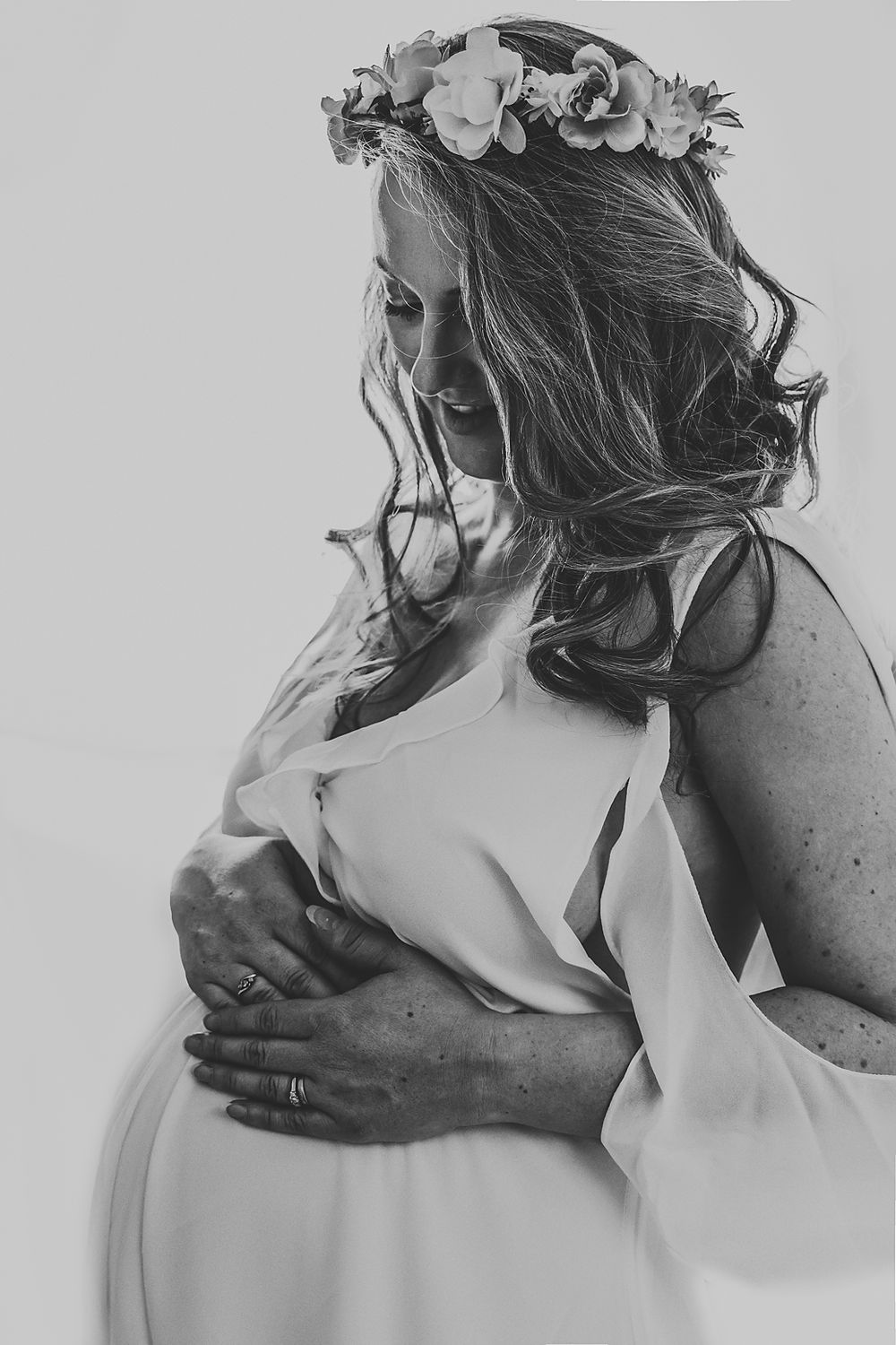 A series of black and white intimate photographs showing a tender embrace between two people.