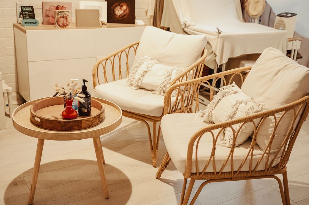 A collection of rattan and bamboo furniture pieces including chairs and tables arranged in a showroom setting.