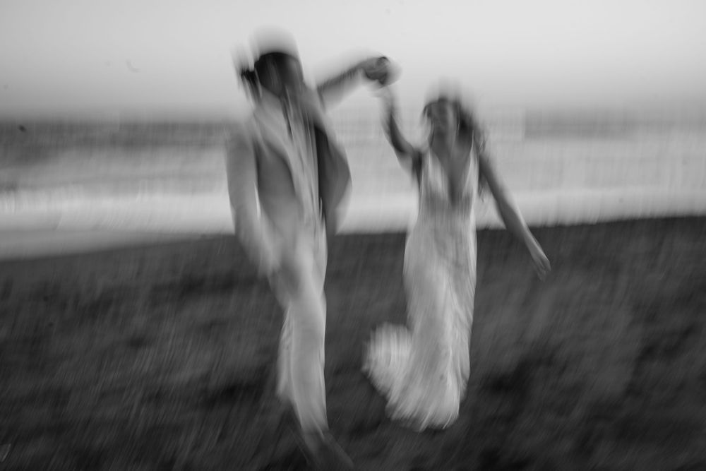 A series of blurry black and white photos showing motion and movement across a field or landscape.