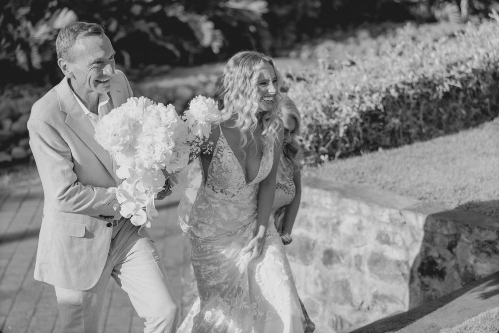 A black and white wedding photo collage showing joyful moments of celebration and embraces during an outdoor ceremony.