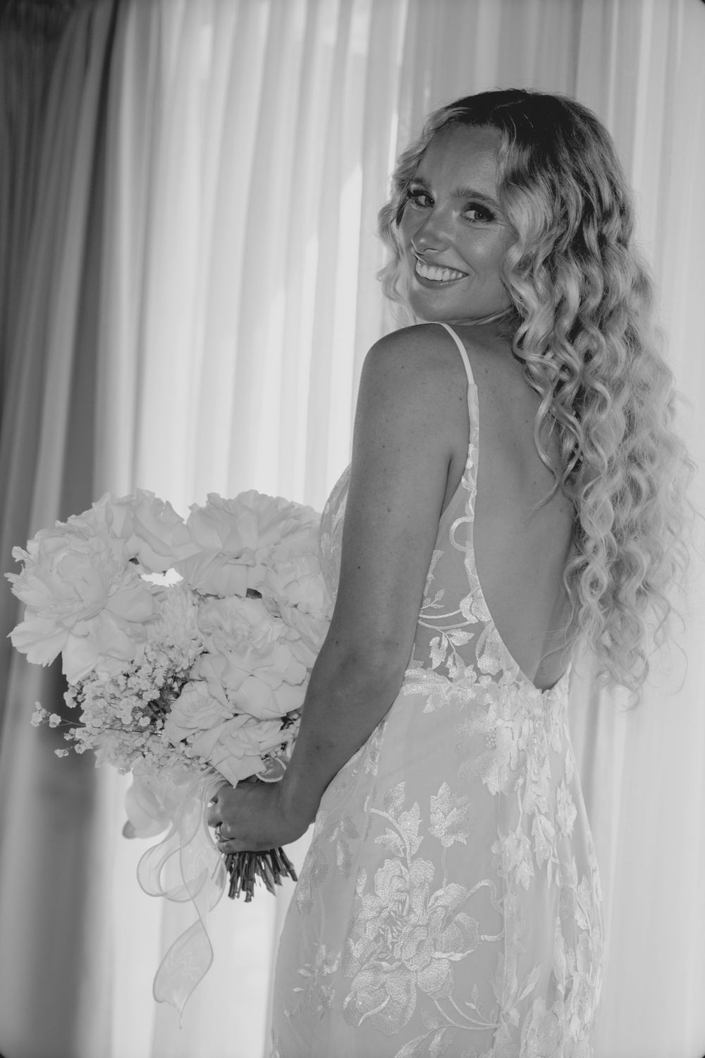 A series of black and white photos showing a bride in a white dress holding a bouquet of light-colored flowers.
