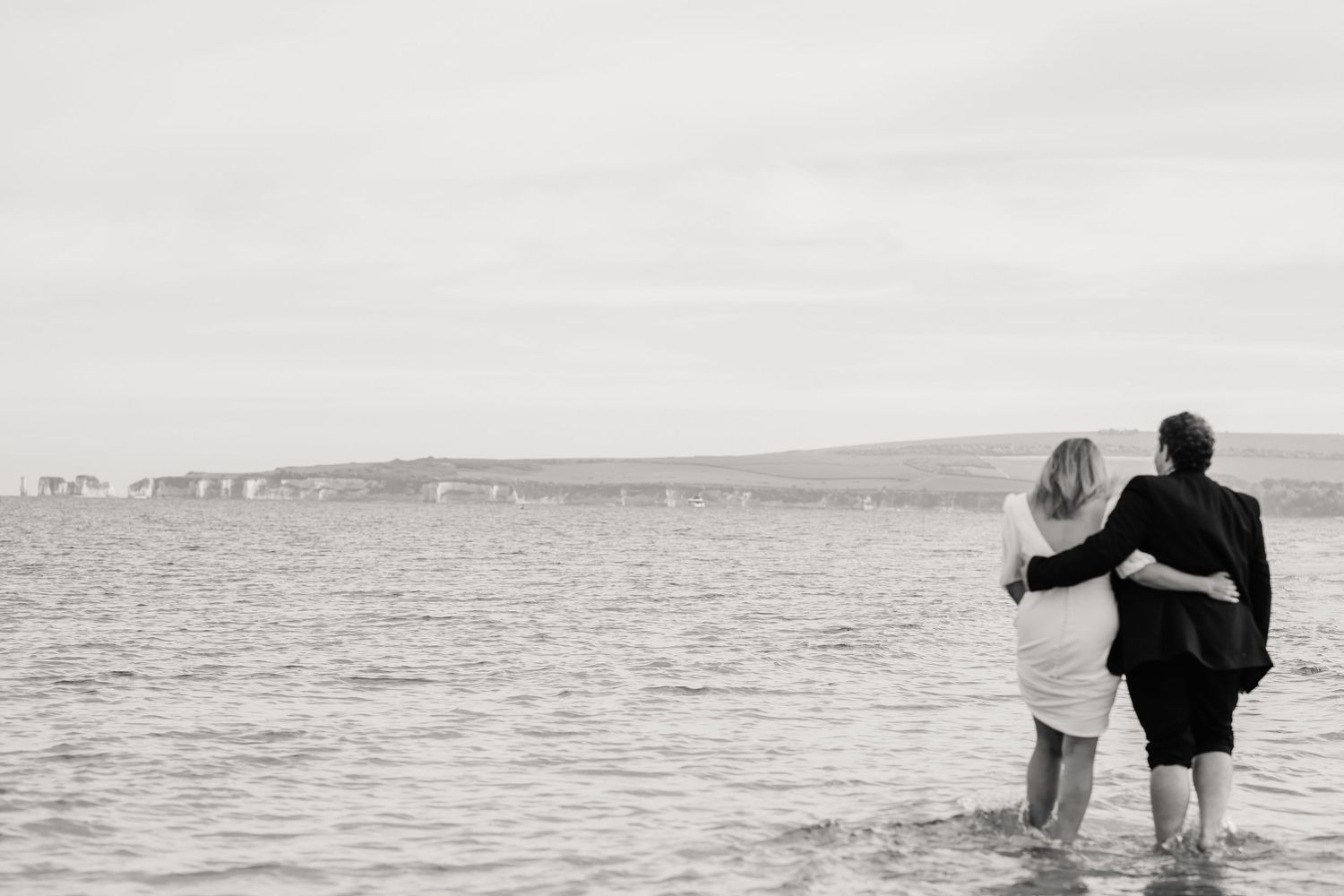 Beach wedding Uk. Beach wedding Dorset. Celebrant wedding Dorset. Beach wedding photos. Paddling in sea. Dorset candid wedding photographer.