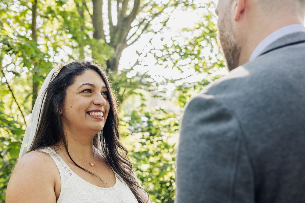 A series of candid wedding photos showing joyful moments between a couple in a lush outdoor garden setting.