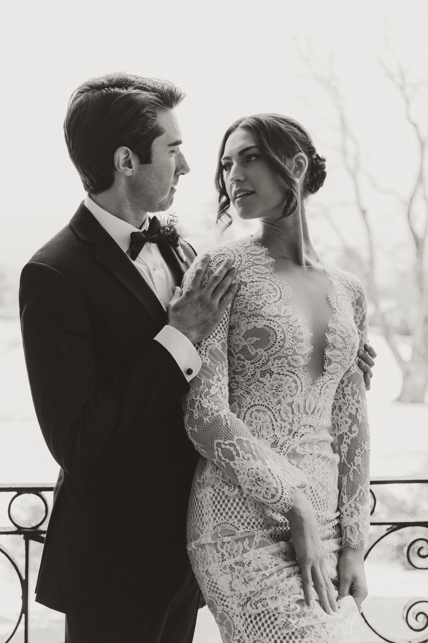 An intimate black and white portrait series featuring elegant wedding attire.