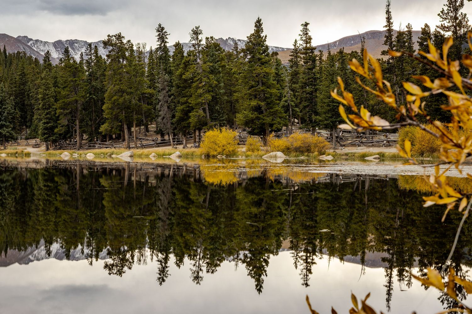The water was calm perfectly reflecting this fall moody scene at Echo Lake, Idaho Springs, Colorado.