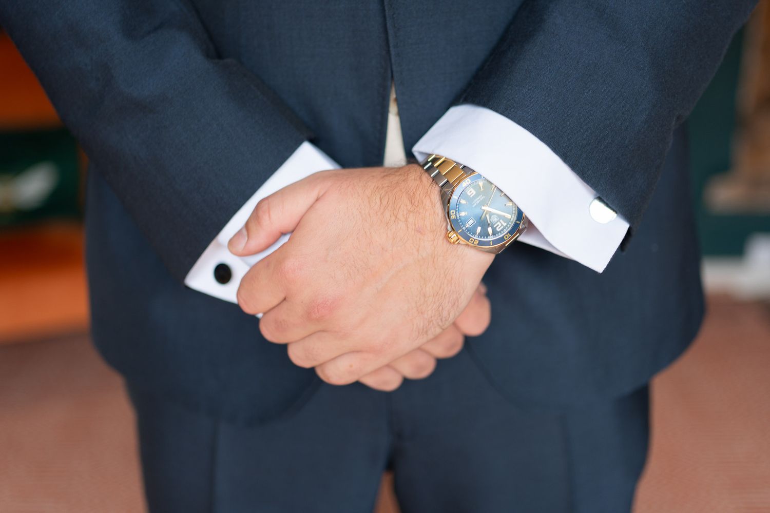 Close-up view of as grooms hands just before his wedding. His watch is clear to see and the time shows its almost time for his wedding.