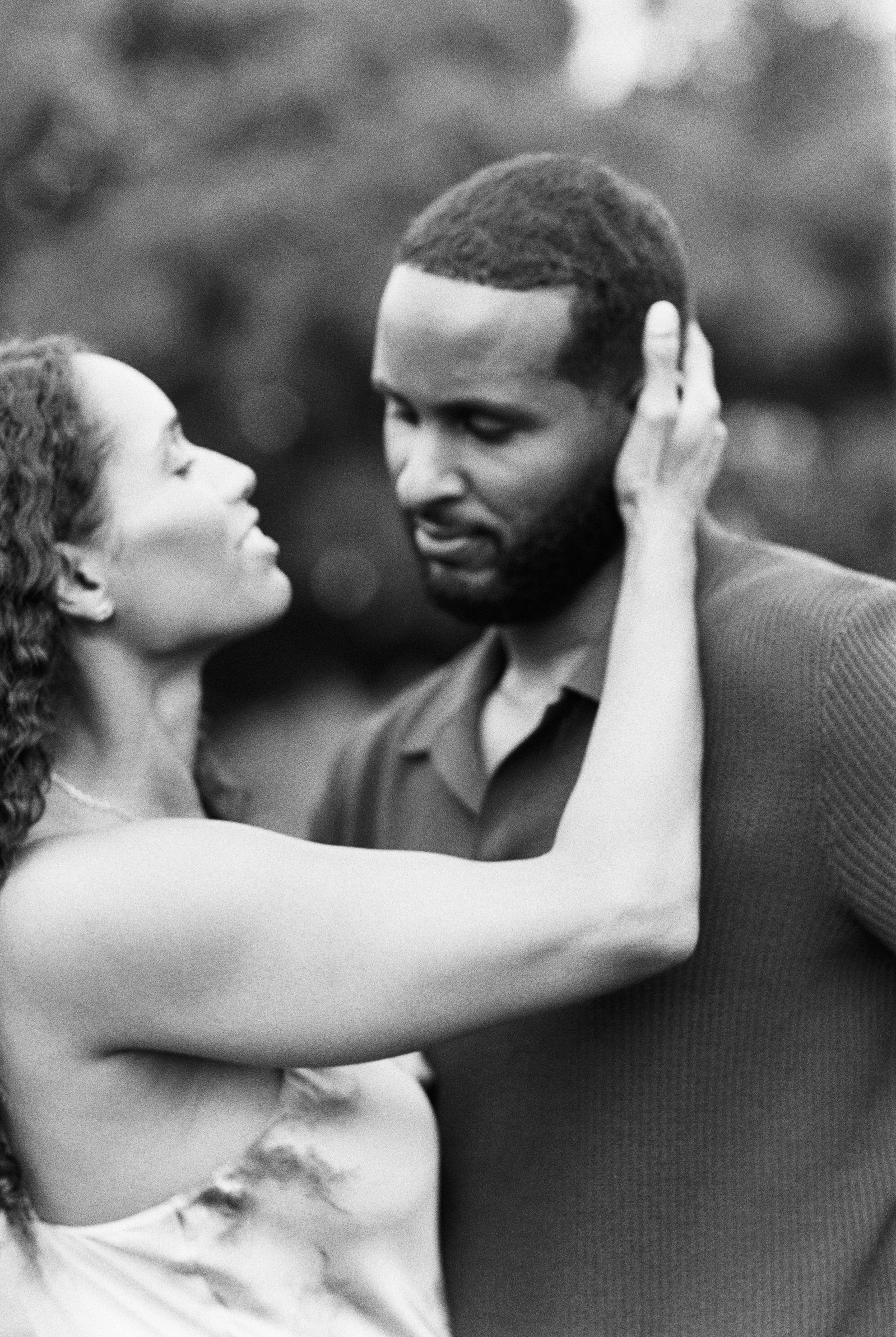 A black and white photo sequence shows an intimate moment between a couple in a romantic embrace outdoors.